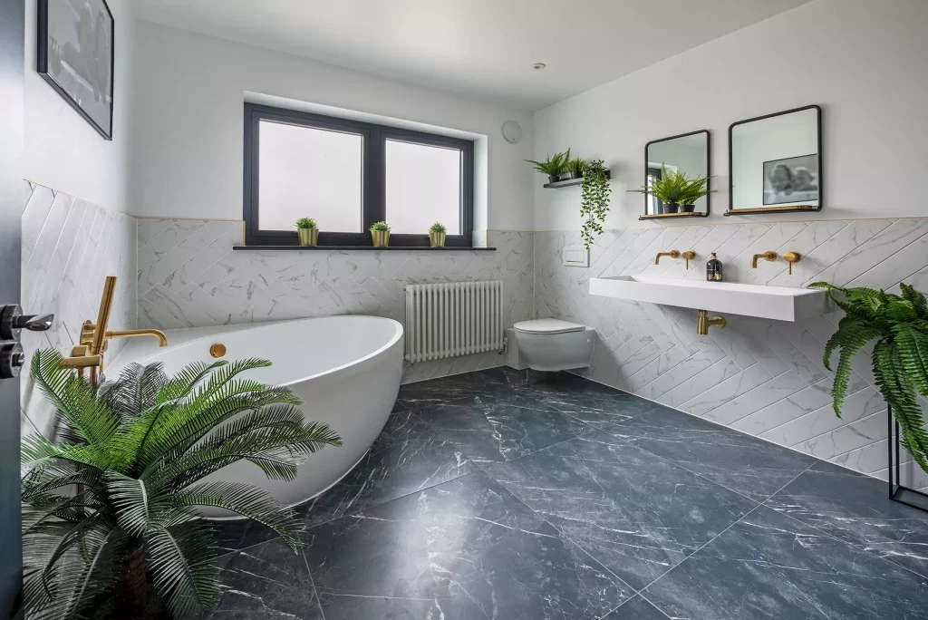 Kevin and Gemma Manning's bungalow renovation bathroom with a mix of marble tiling and metalic brassware