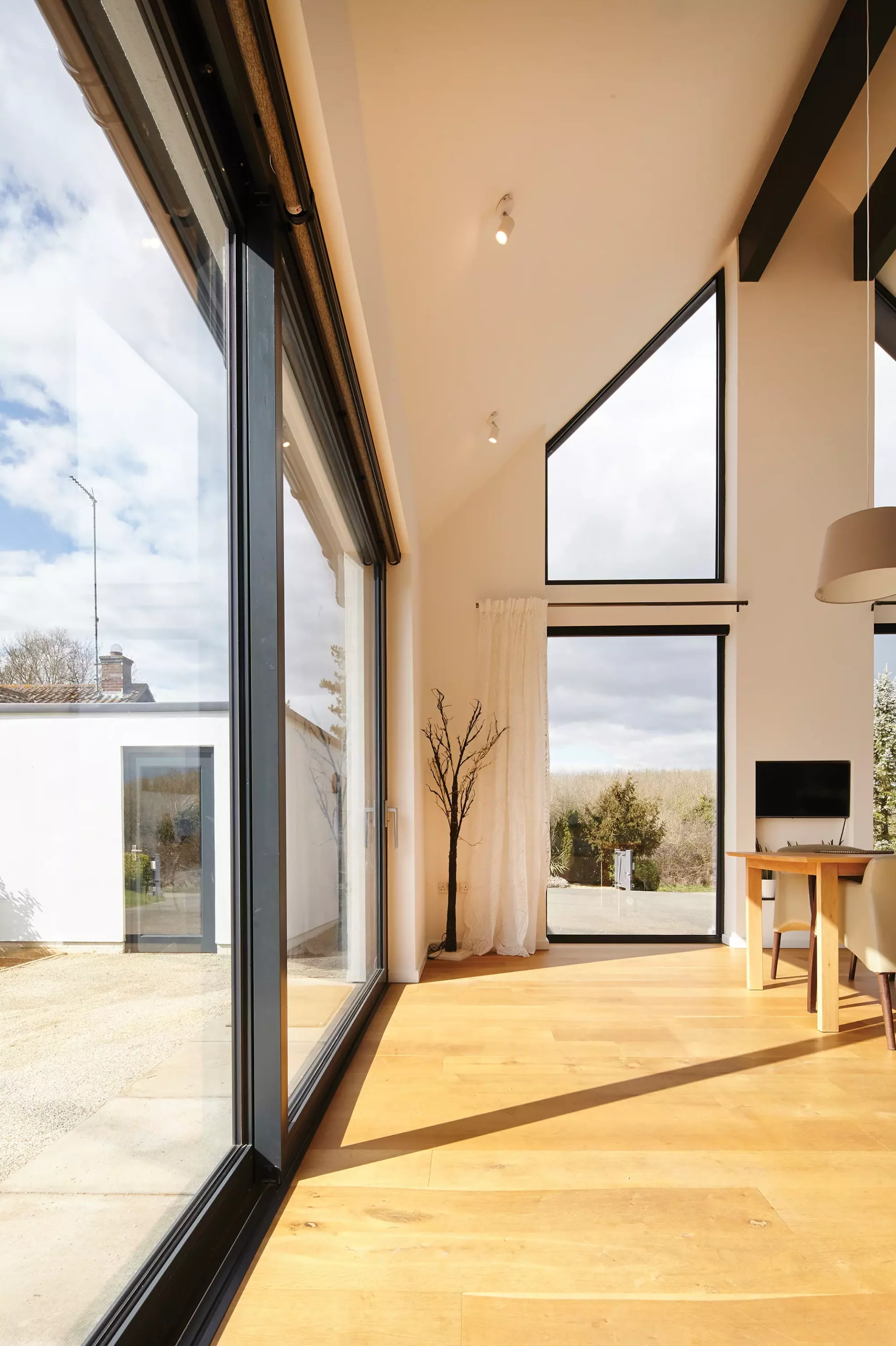 A sun lit extension project with tall windows 
