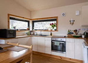 small open-plan kitchen with chestnut worktops and oak flooring