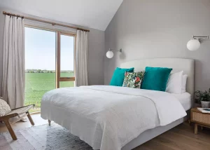 Master bedroom with full length glazing over the farmland