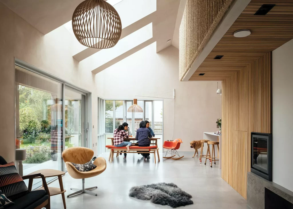 open plan living-dining area with roof glazing and plaster walls