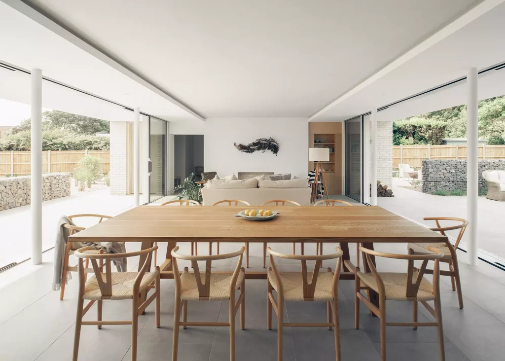 Open plan dining and living area with full-width glazing on both sides 