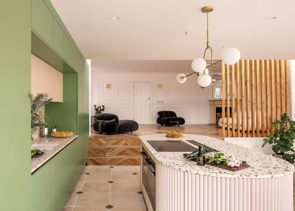 split level open plan kitchen-diner extension with green cabinets and timber partition wall