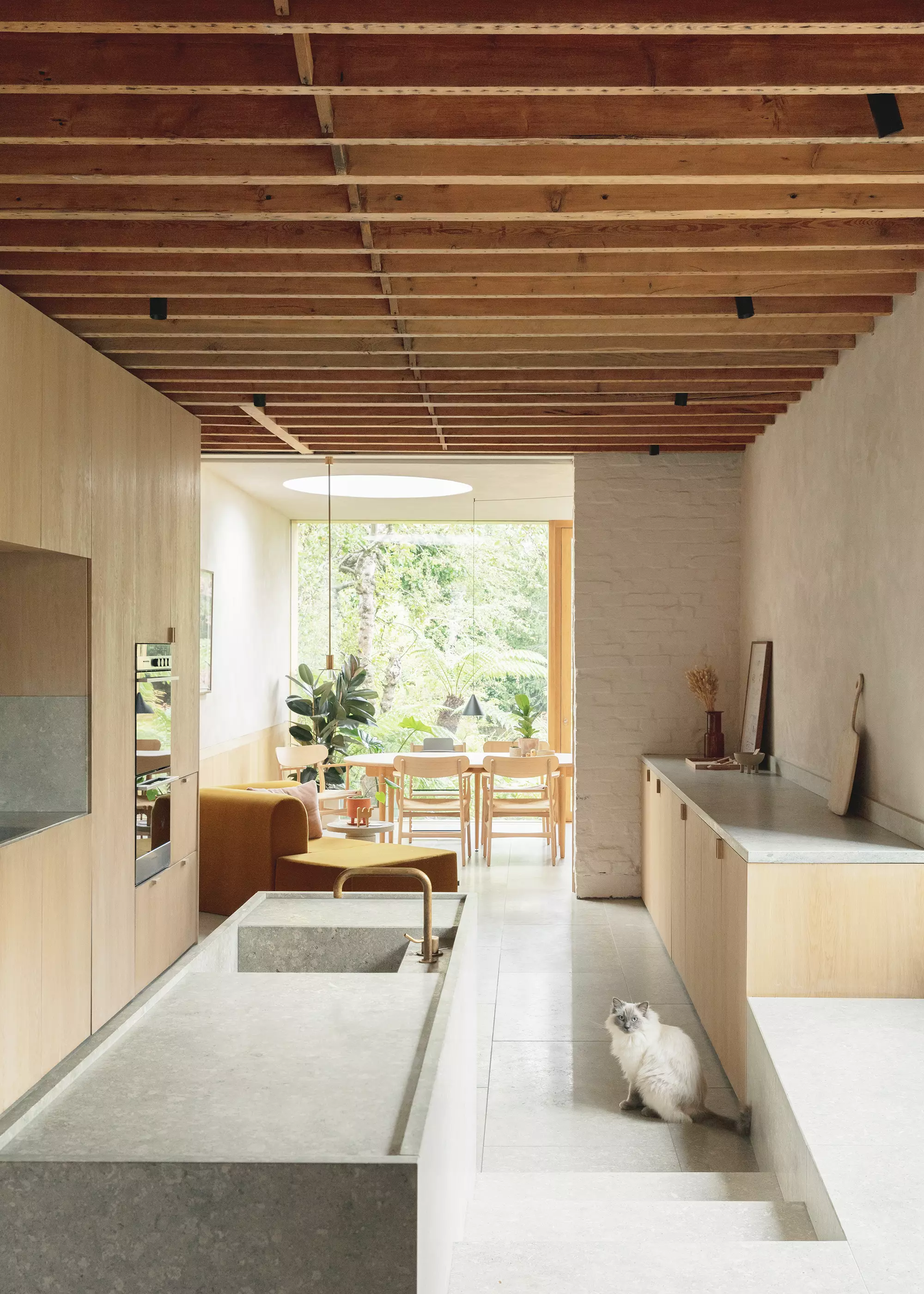 contemporary open-plan kitchen design with concrete floor and exposed ceilings