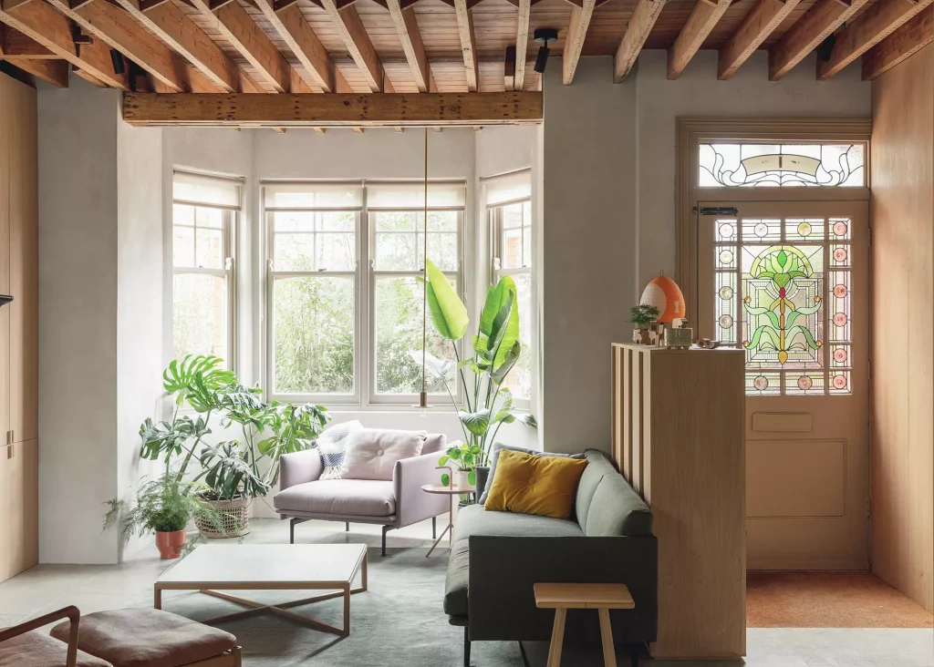 Open plan living room area with traditional bay windows, contemporary-style interior