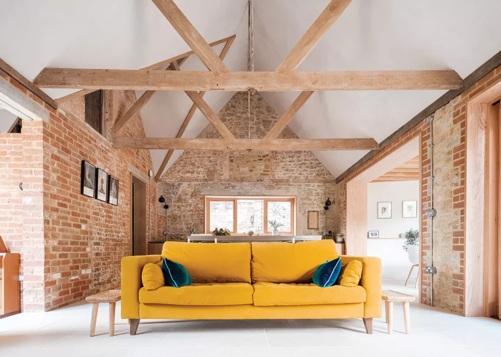 Open plan stable renovation with exposed vaulted ceilings and brick walls