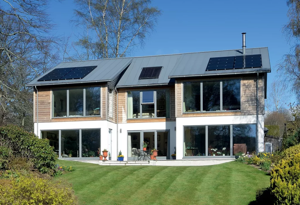 turnkey home exterior with split timber cladding and white render finish