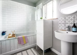 light-filled bathroom with combined shower bath and white tiling