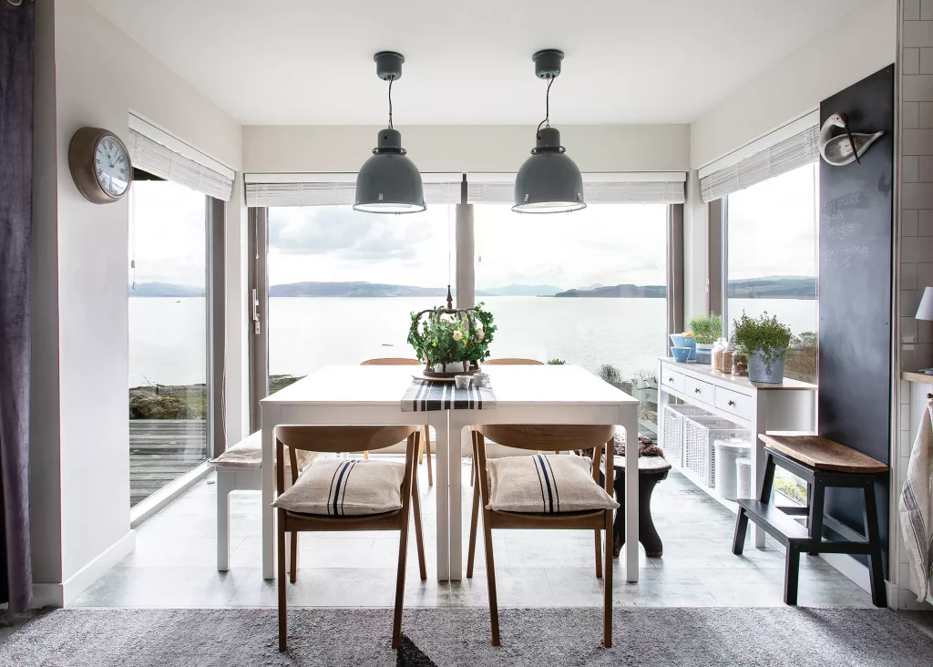 dining room area with surrounding glazed doors and views over the south-east sea