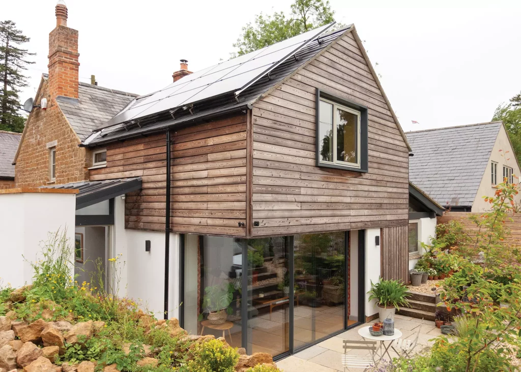 larch cladding and white render extension to a period cottage