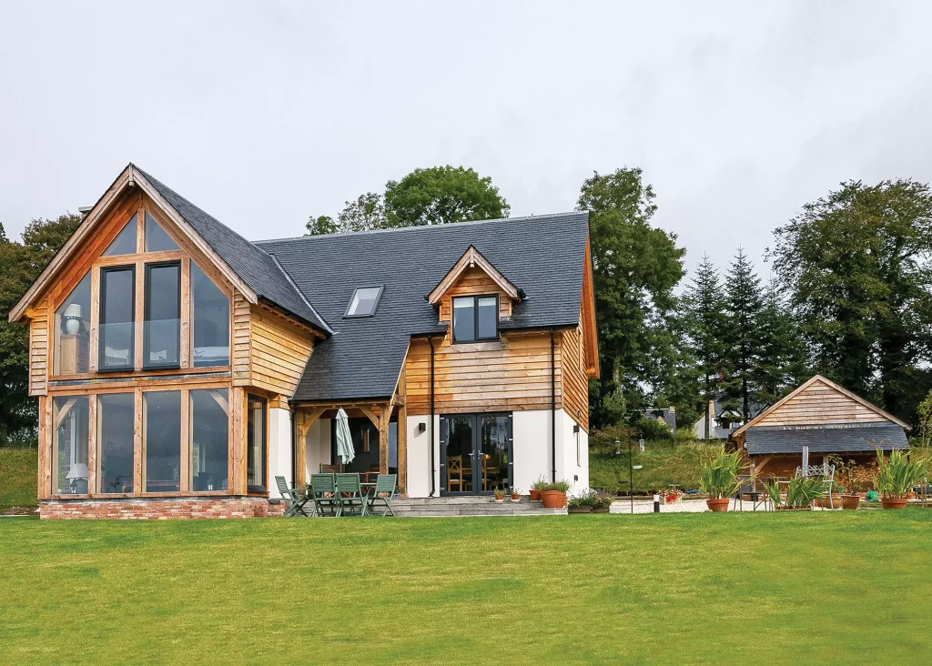 Oakwrights turnkey home clad in render and larch weatherboarding