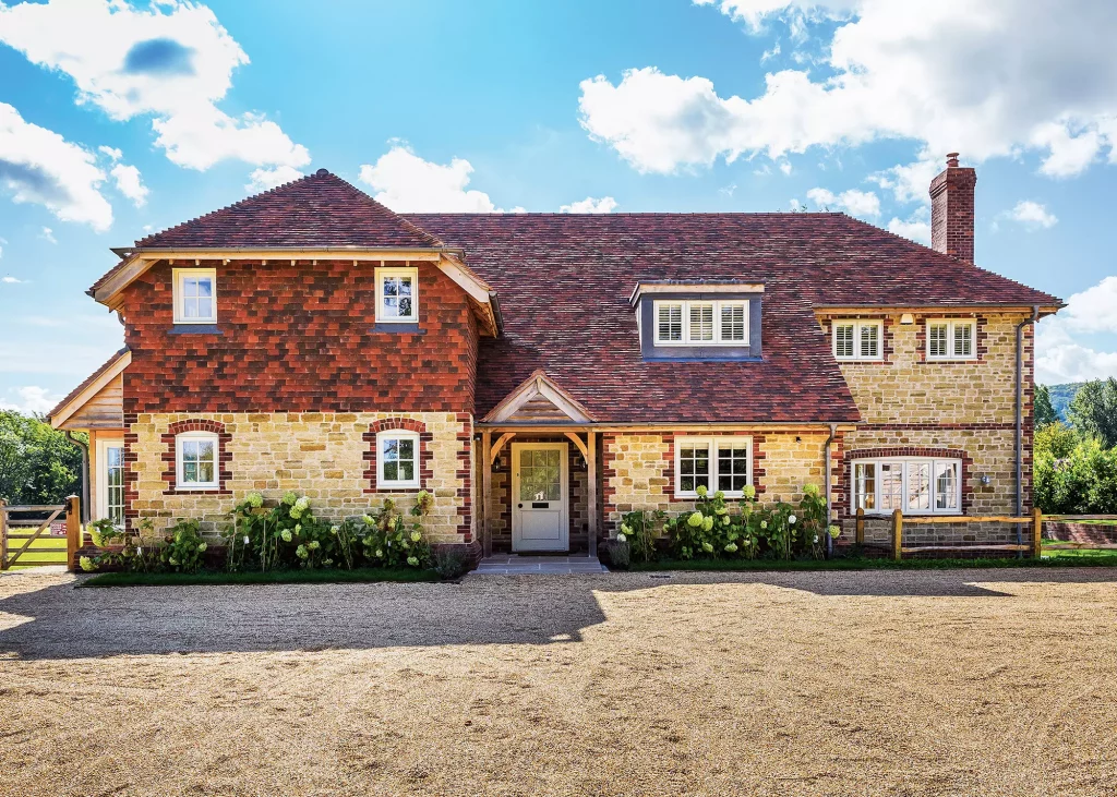 Timber frame home clad in stone from a quarry with clay tile roof