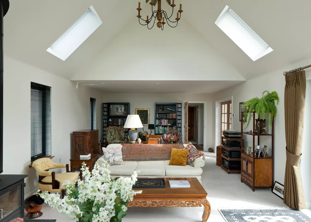 timber frame home living area with rooflights in vaulted ceiling