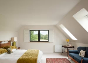 bright master bedroom with rooflights in the vaulted ceiling