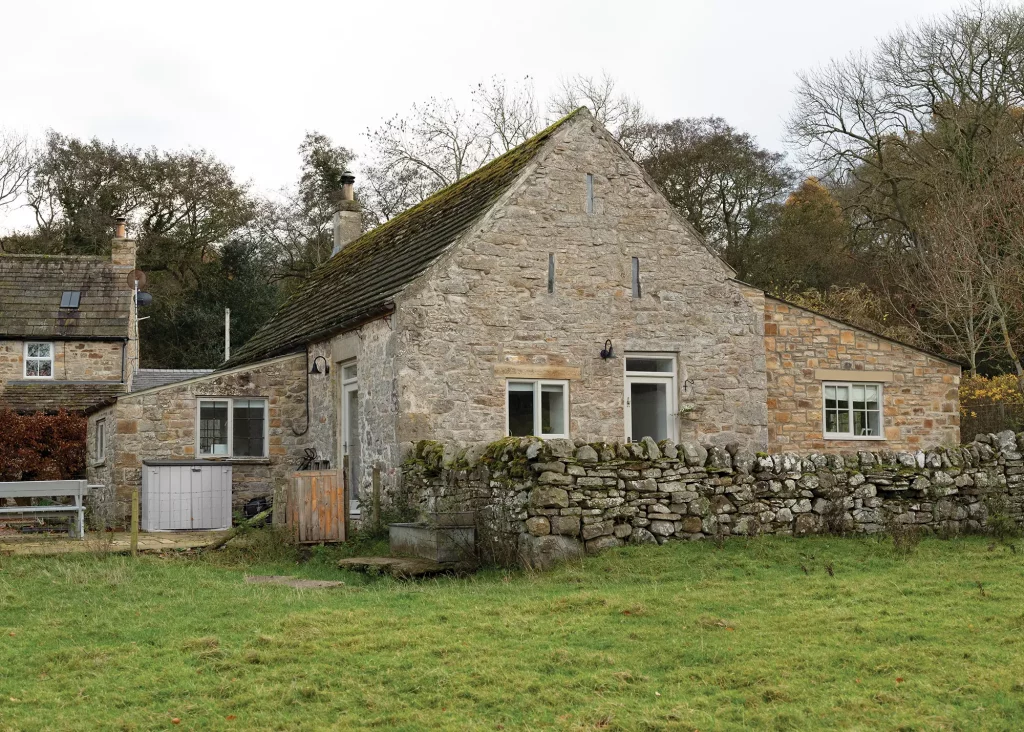 stone barn exterior with surrounding dry stone wall