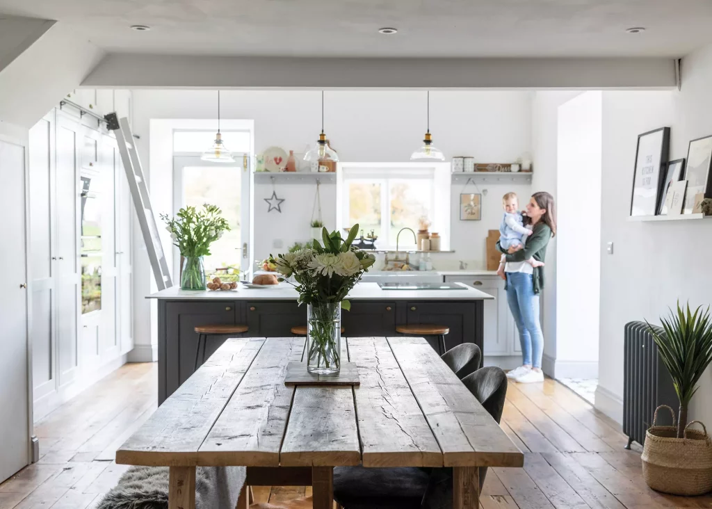 open plan kitchen dining area with shaker-style kitchen and wooden features