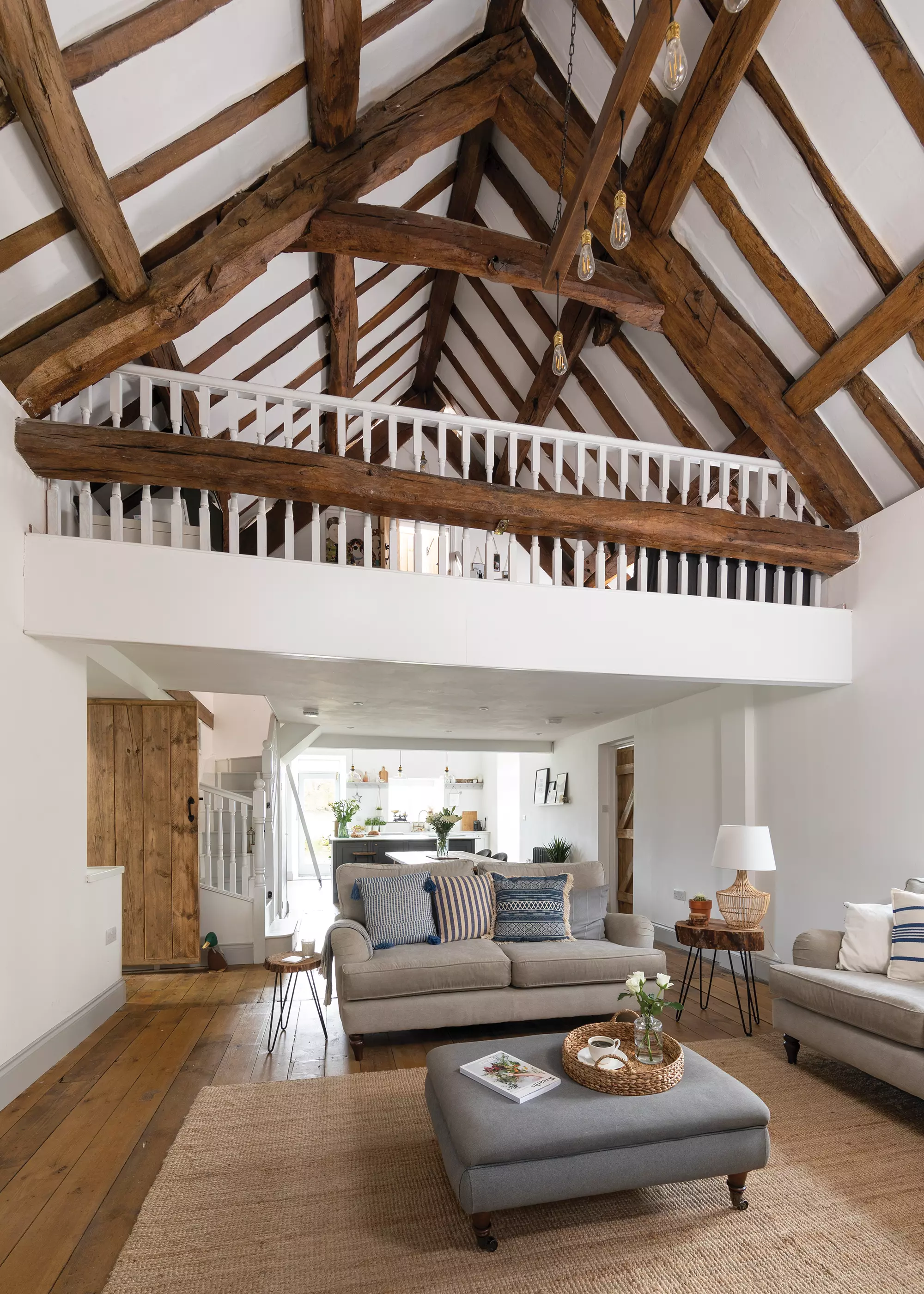 living room area with exposed beams and vaulted ceiling