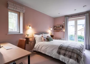 large double bedroom with pink walls and french doors