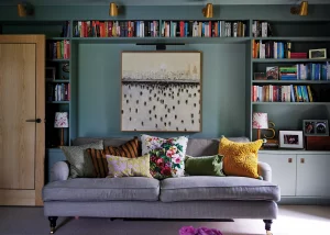 dark-toned living room area with built-in book shelving units