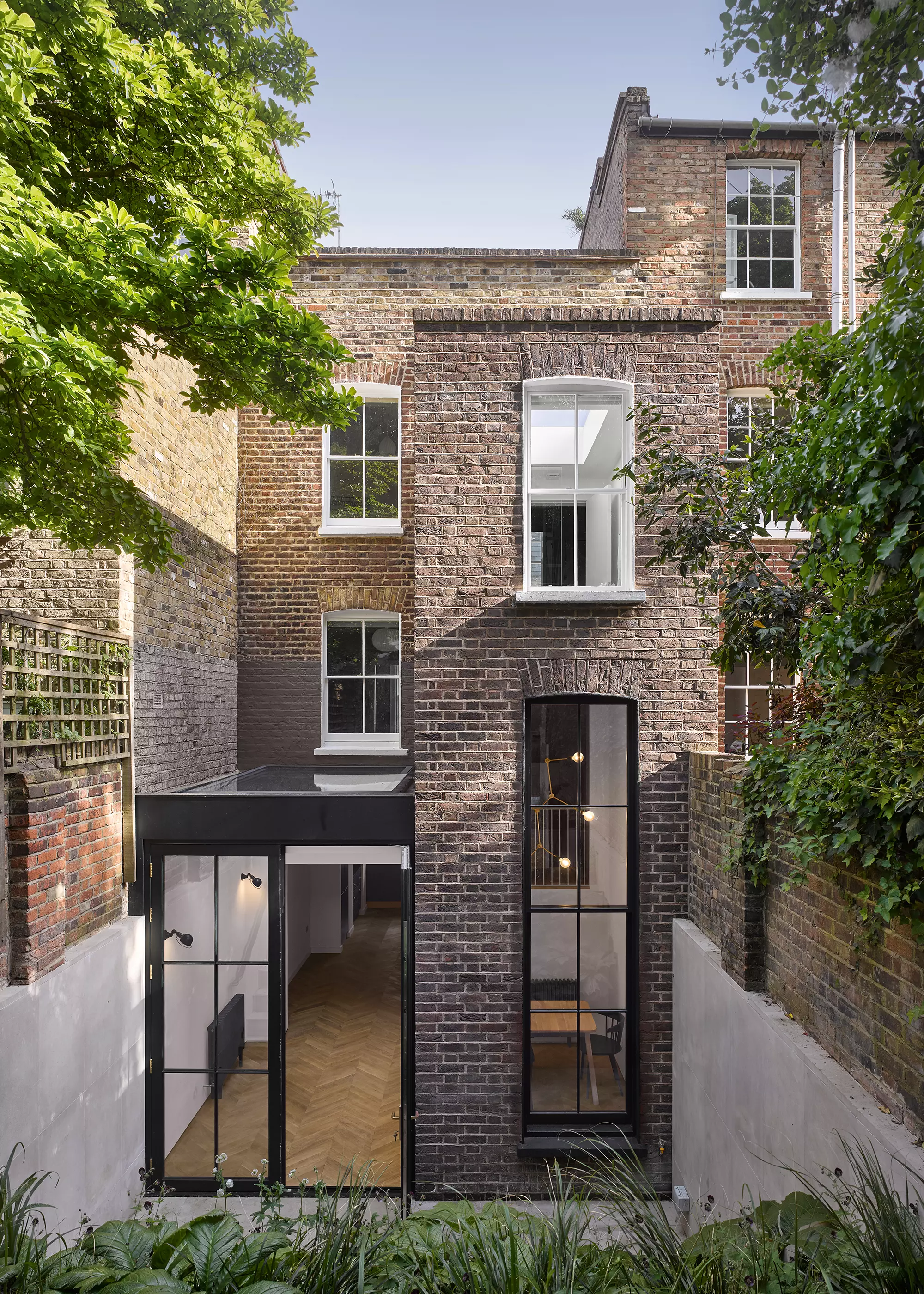 two-and-a-half storey tower extension at the rear of 1830s grade II listed home in Islington