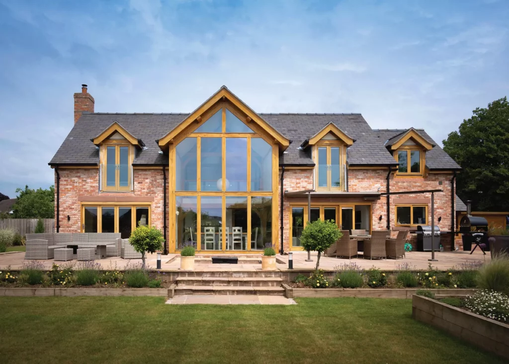 Royan and Helen Anthony self build oak frame home exterior with masonry facade and glass atrium
