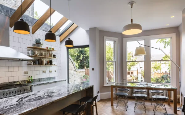 traditional style kitchen-diner extension with bay windows and pitched glazing in the side return