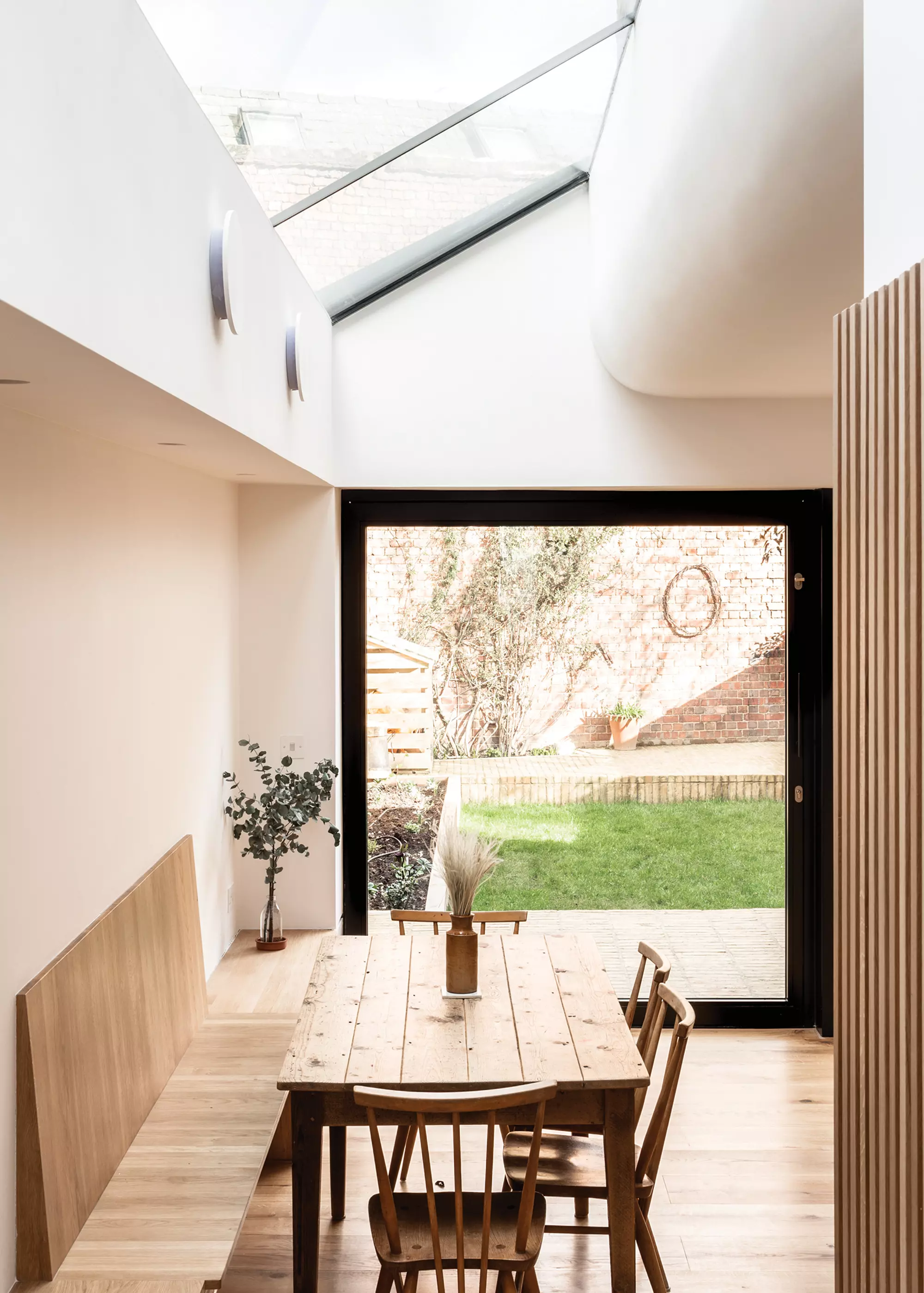interior of side return extension with wooden bench seating area