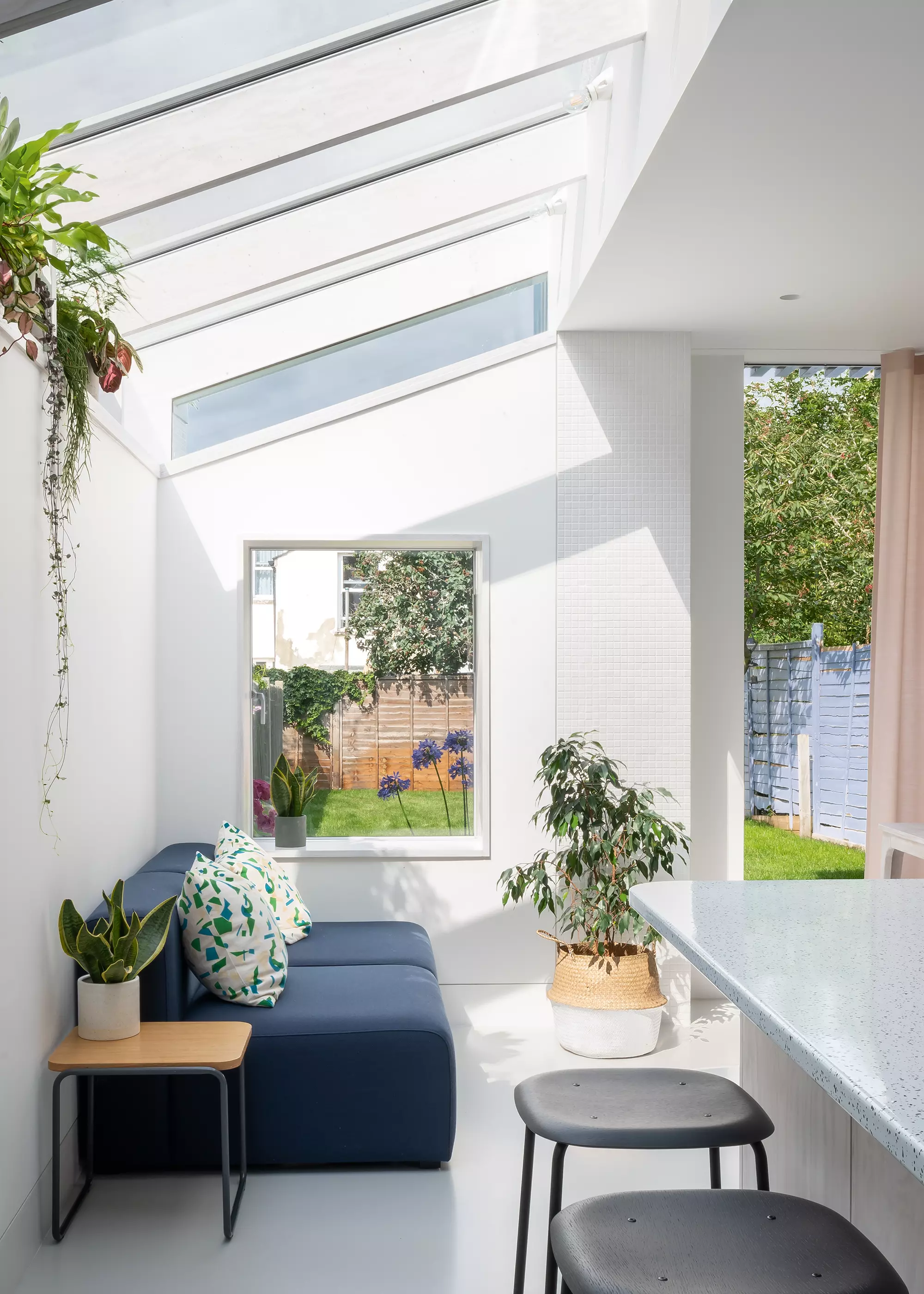 side return extension seating area with white walls and pitched overhead glazing