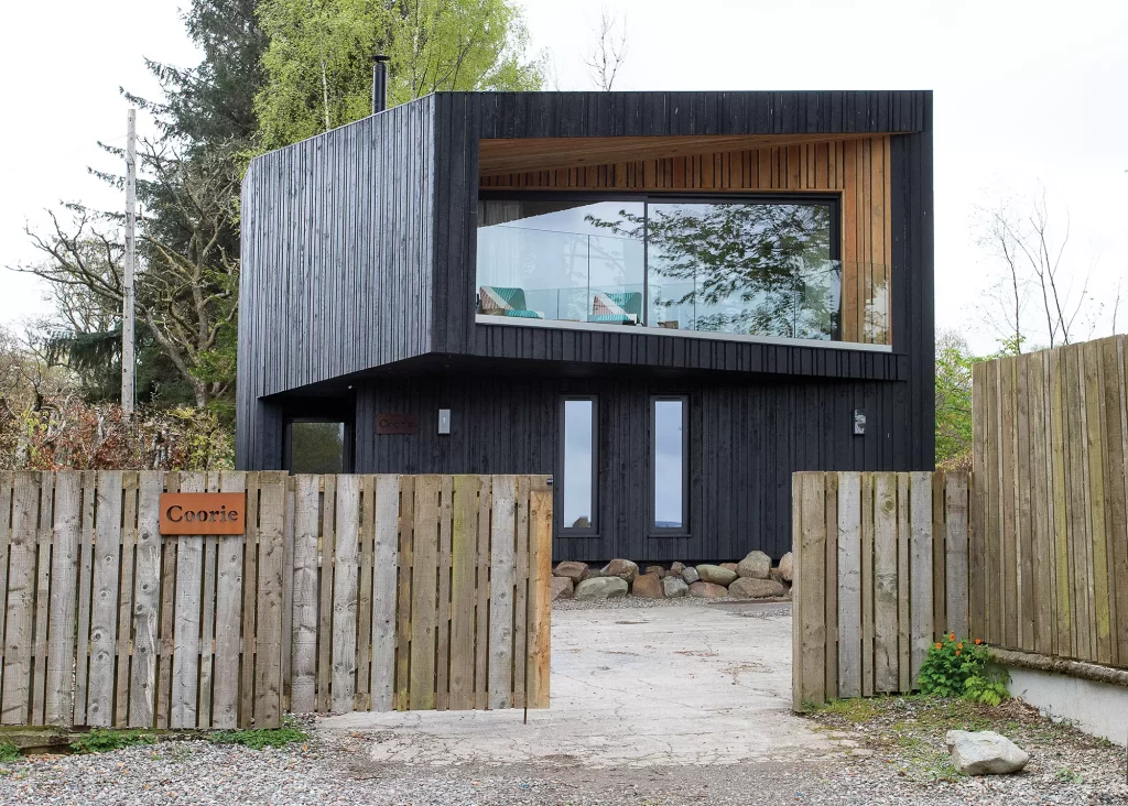 striking affordable self build with dark cladding and expansive glazing