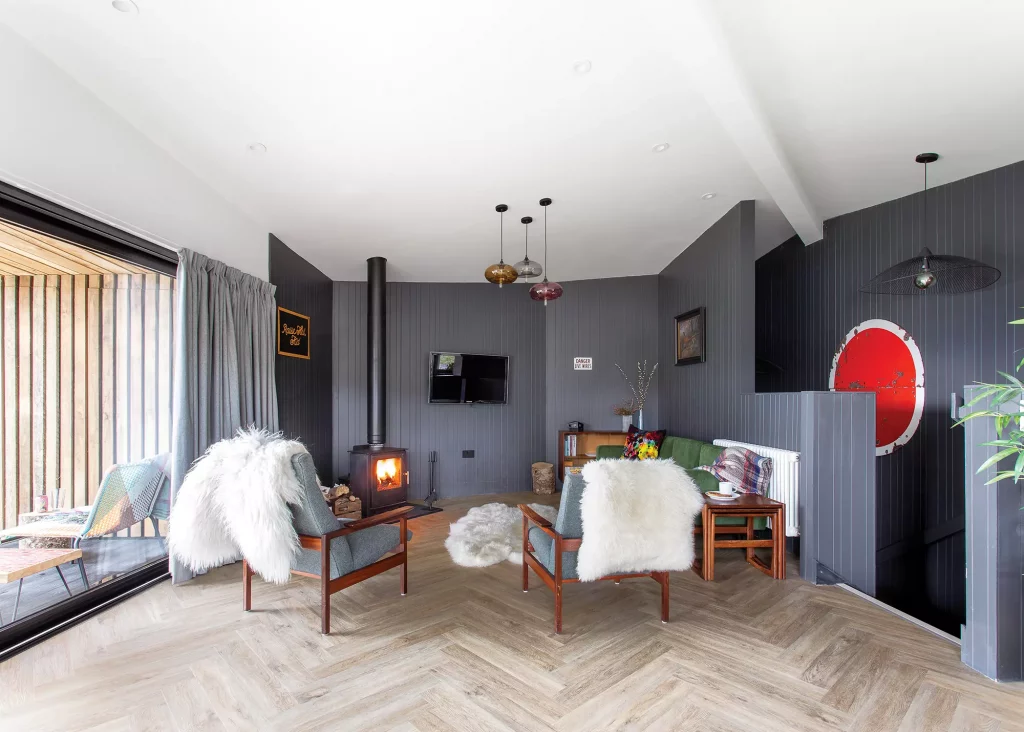 angled dining room with contemporary design, wall cladding and woodburner from Direct Stoves