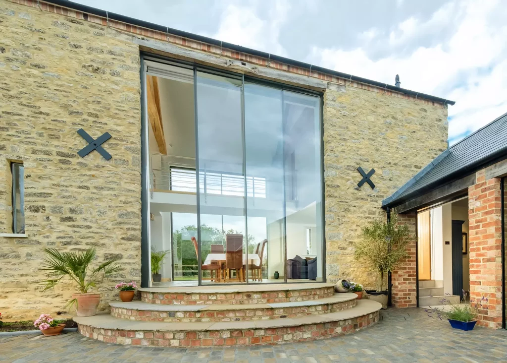 barn conversion with statement full-height double-storey glazed sliding doors