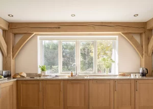 kitchen with exposed beams and large windows