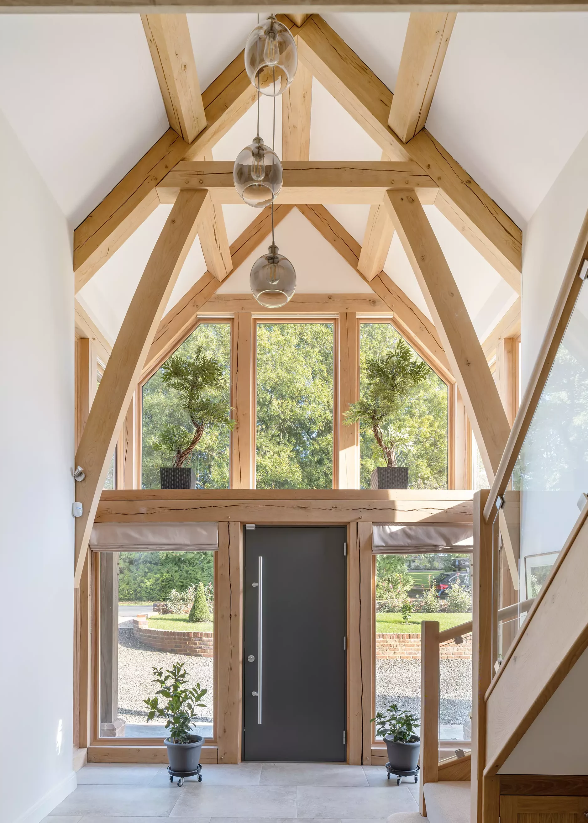 hallway with vaulted ceilings and exposed oak frame trusses
