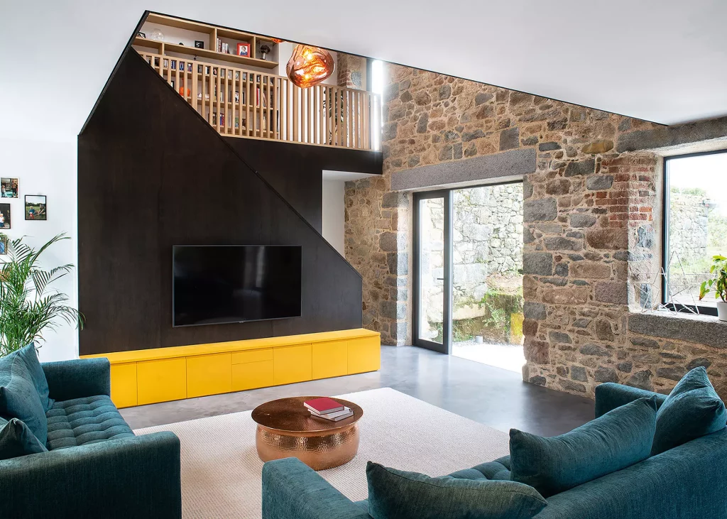 Granite barn conversion with exposed stone wall interior and statement staircase