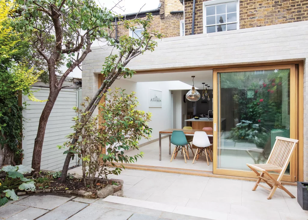 exterior view of wraparound side return extension with wood-framed glazing