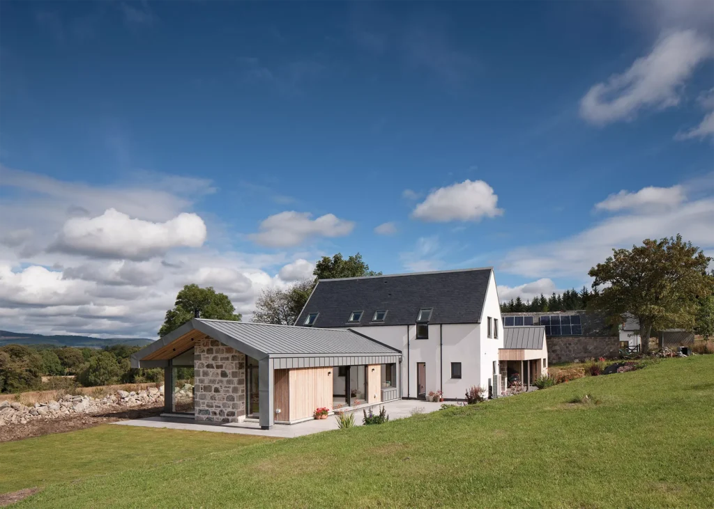 self build home with larch cladding and white render exterior