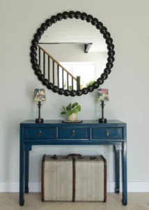 hallway with large circular mirror