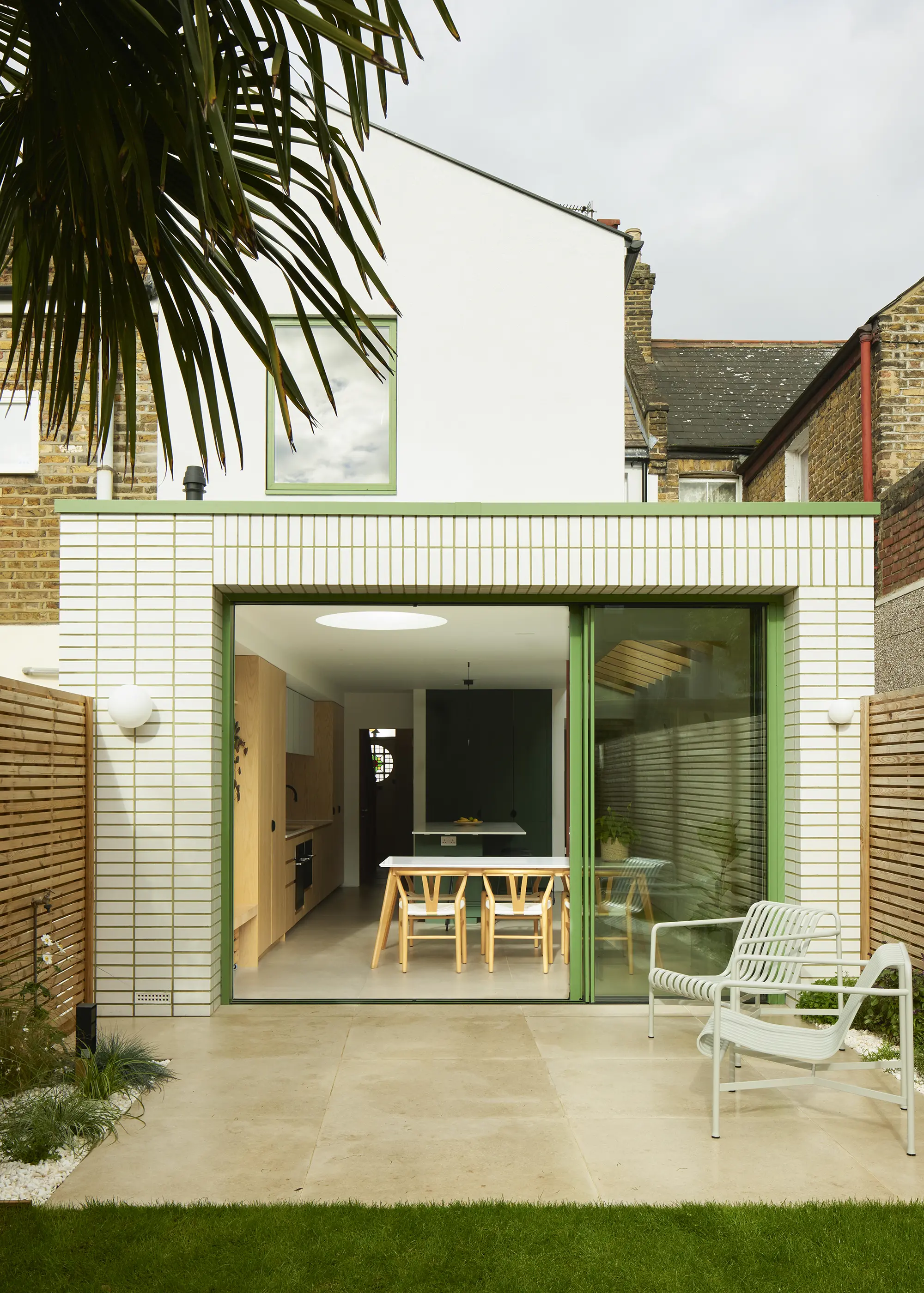 Wraparound House Extension Finished with White Glazed Bricks