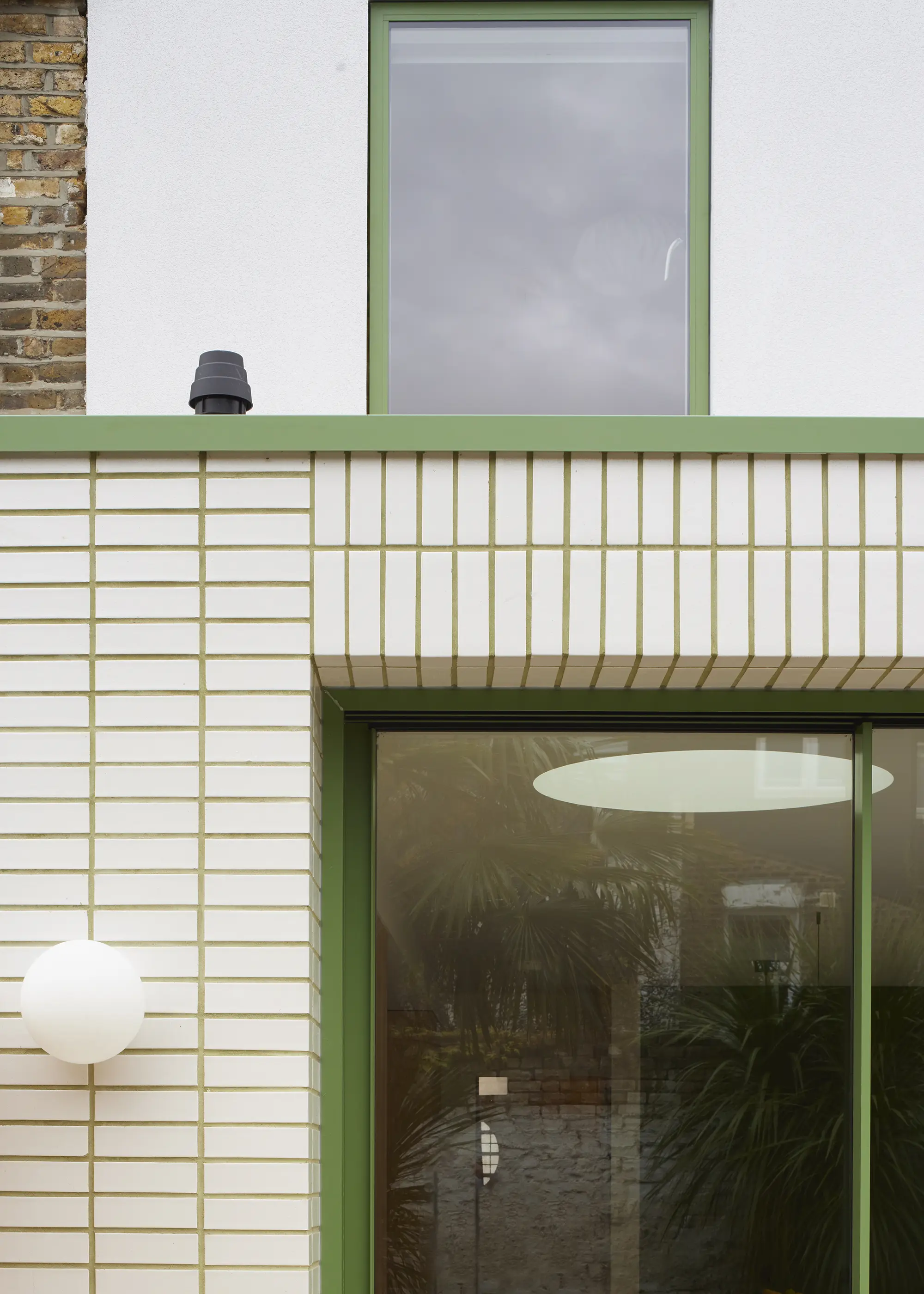 Wraparound House Extension Finished with White Glazed Bricks