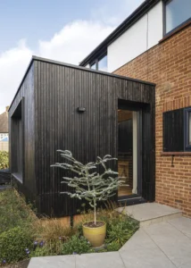 1950s House Opened Up to the Garden with a Timber-Clad Extension