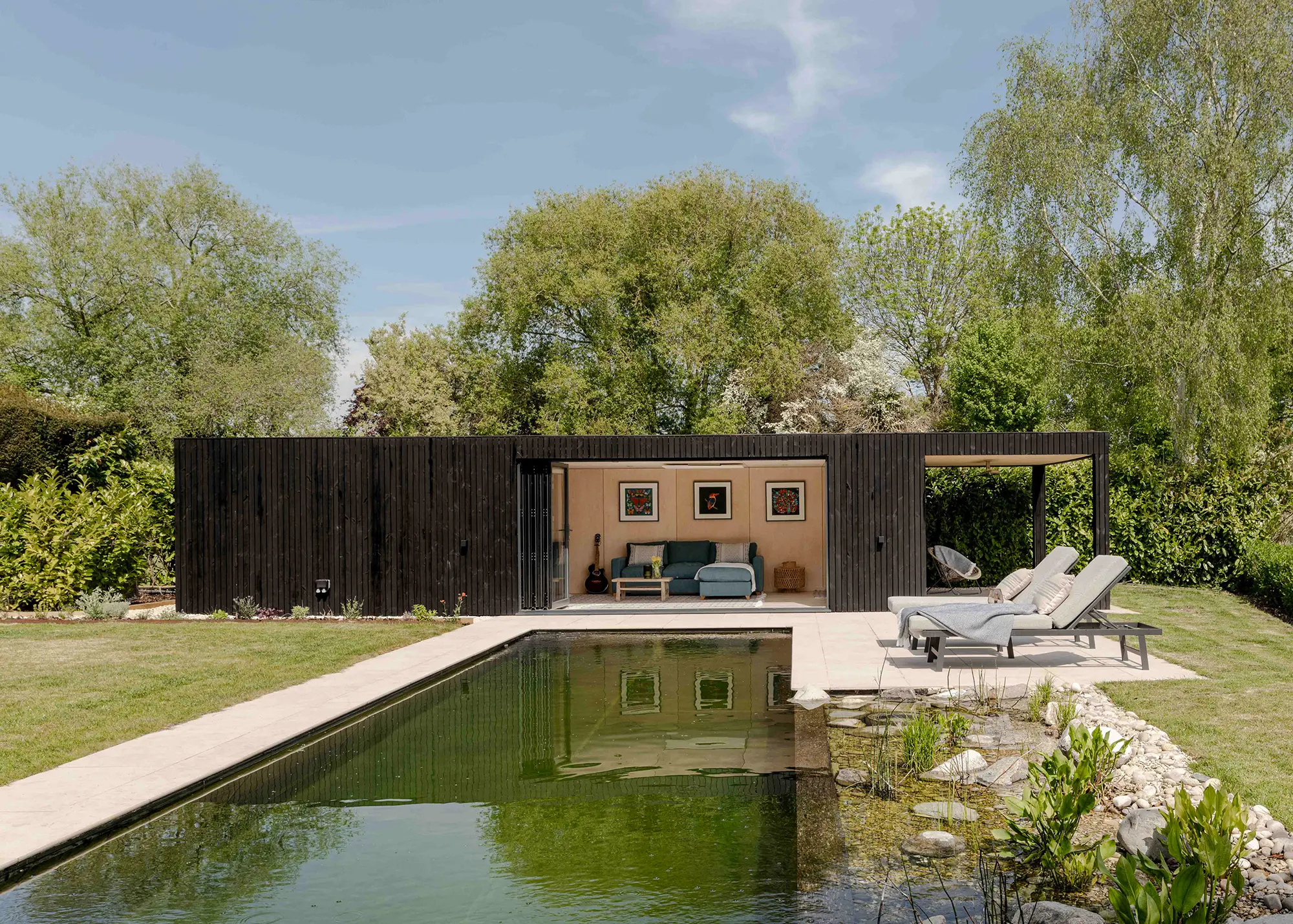 Prefabricated pool house outbuilding with bifold doors