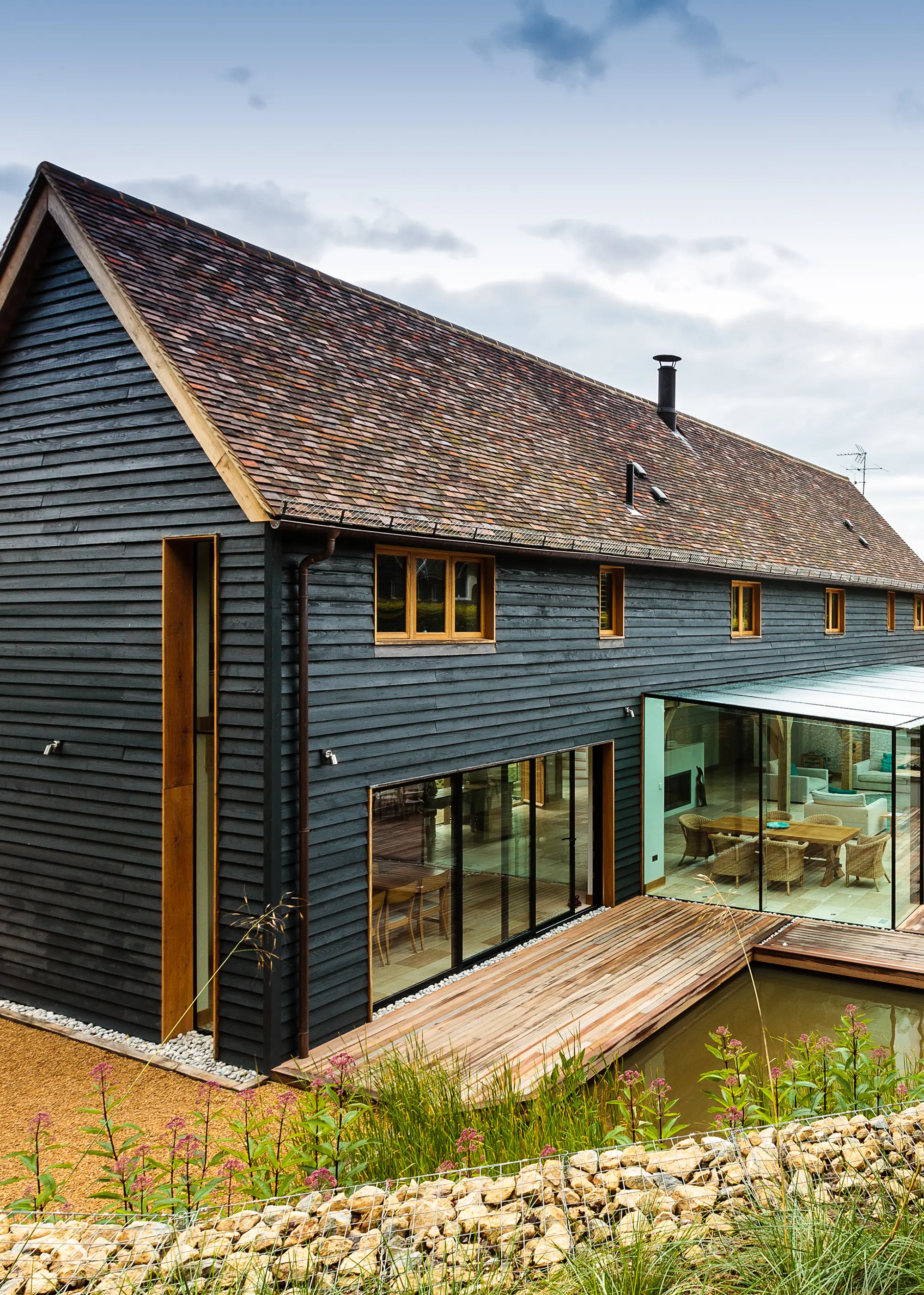 Sympathetic oak frame home with a black timber exterior