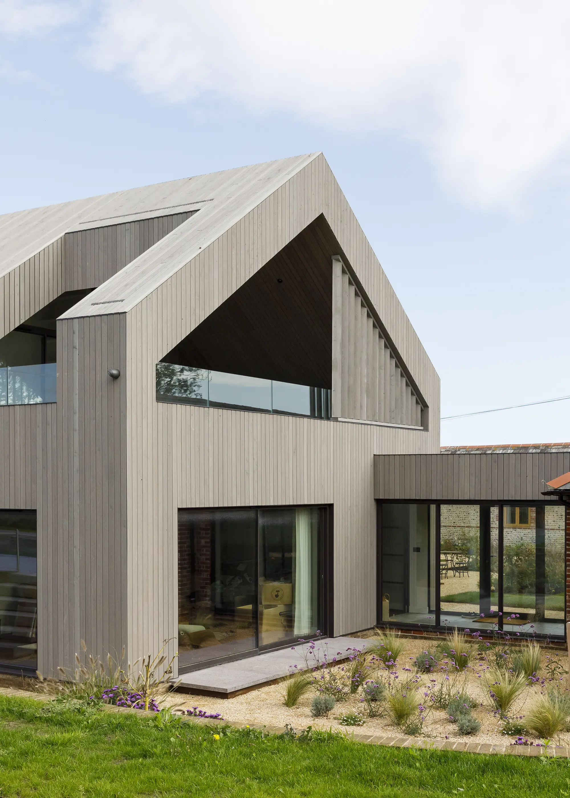 Dutch barn upgraded with a modern timber-clad extension