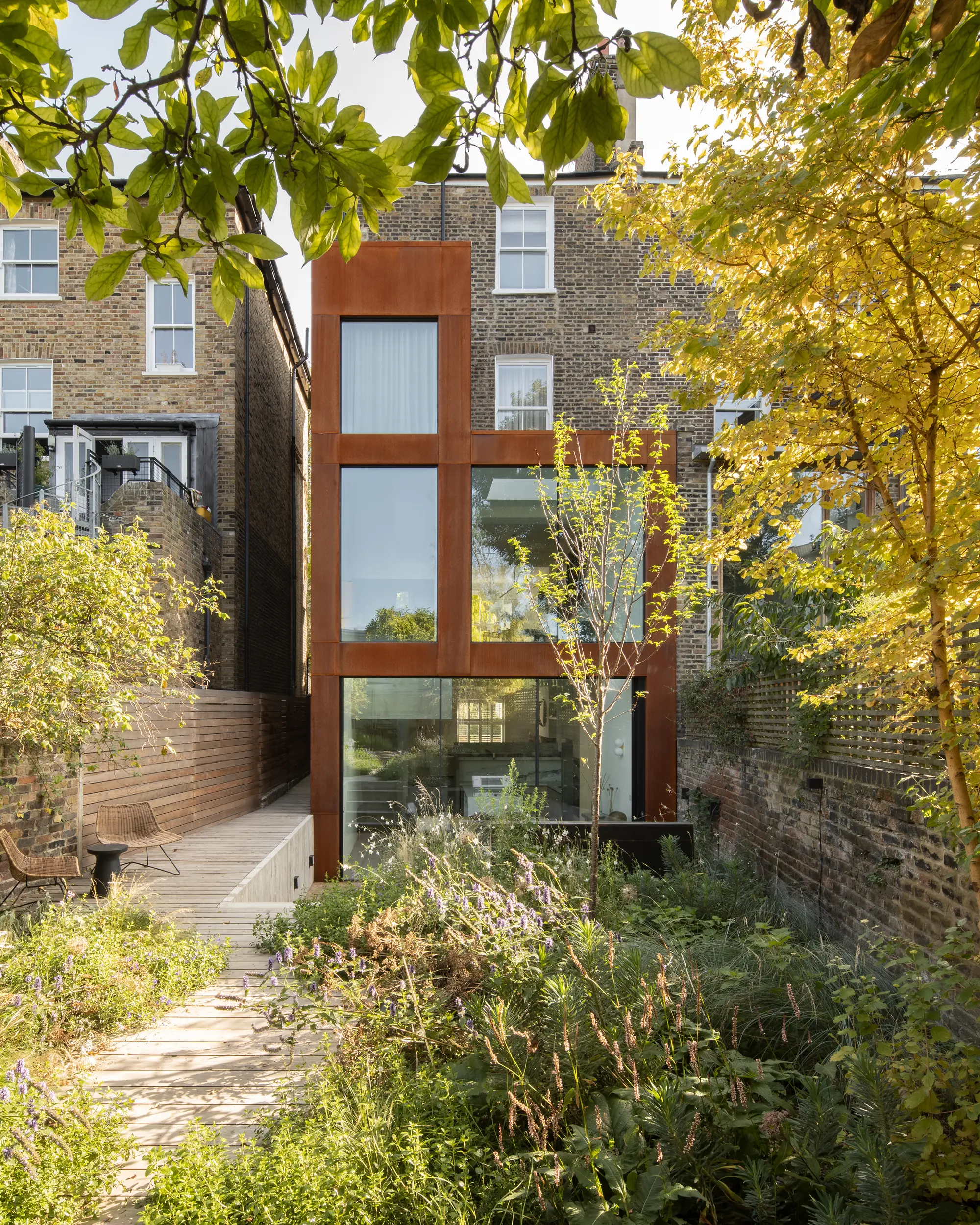 Corten steel semi-detached home rear extension with a tranquil sunken terrace
