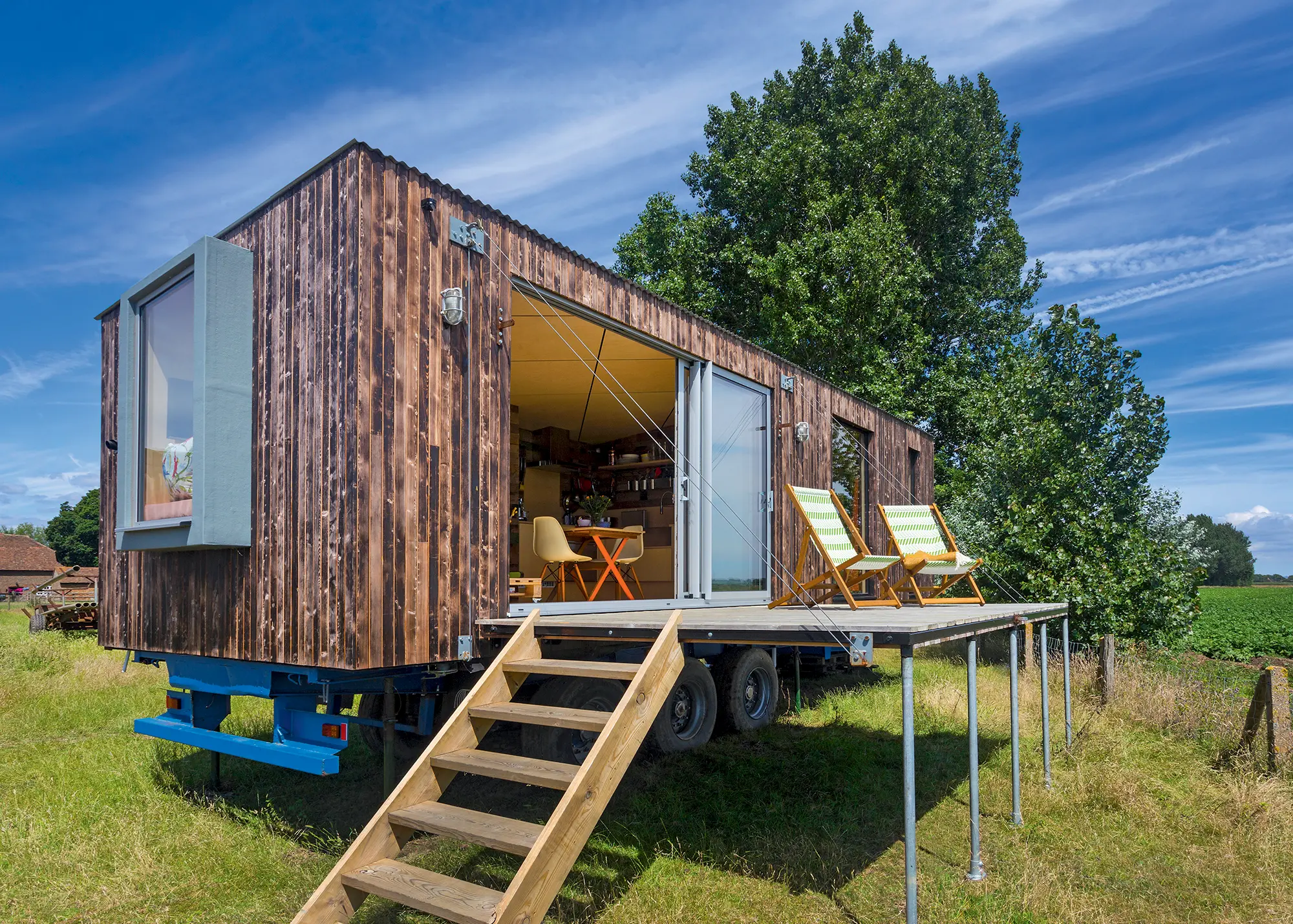 Mobile timber frame tiny home with glazed sliding doors