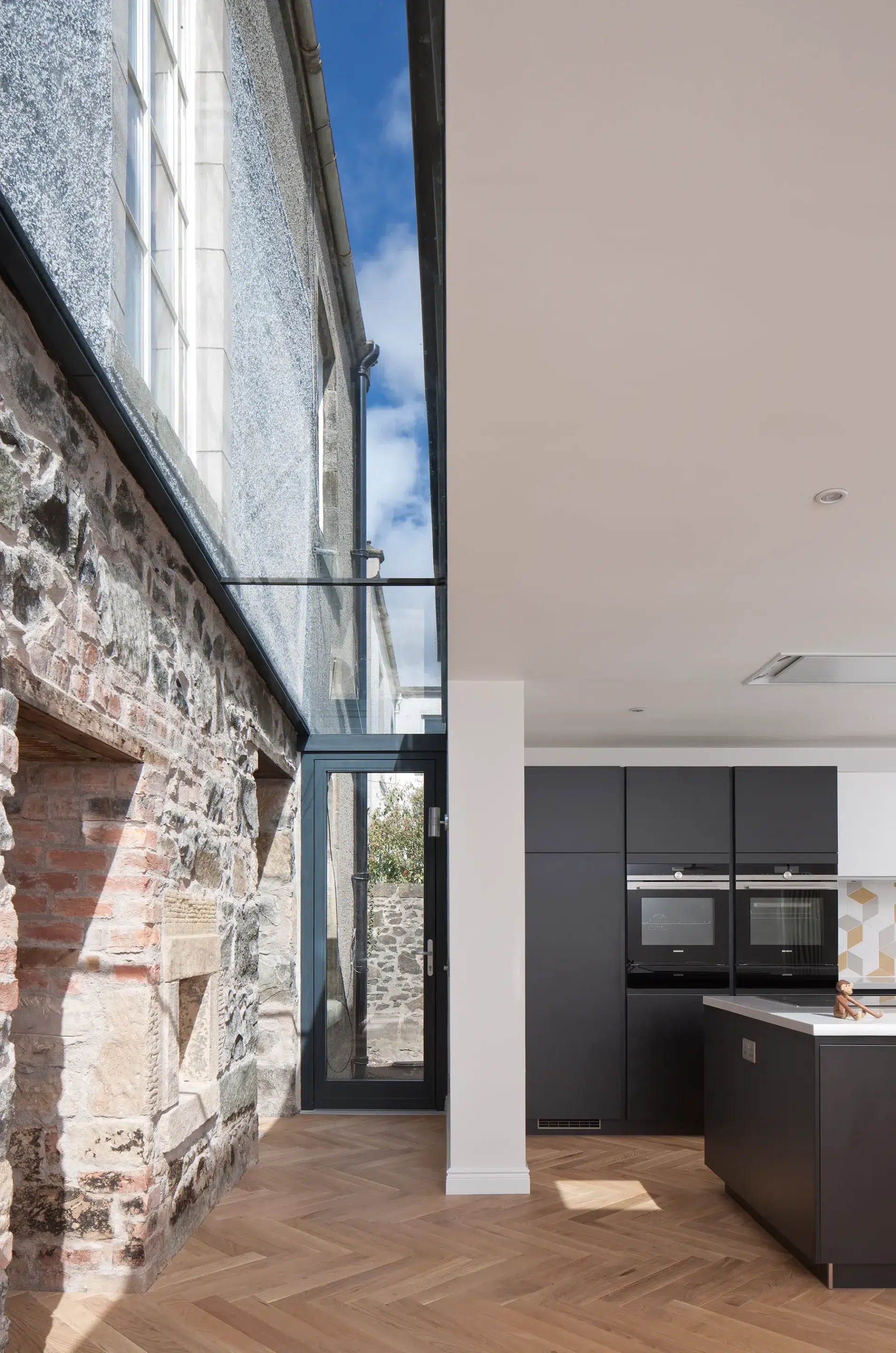 Modern SIPs addition to historic semi-detached listed home