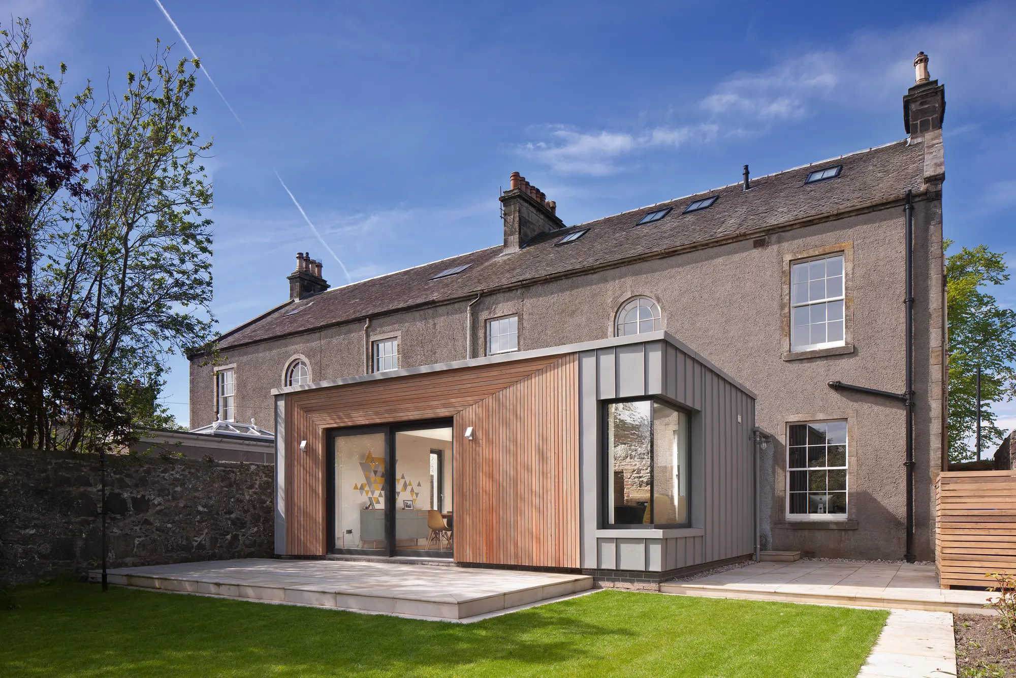 Modern SIPs addition to historic semi-detached listed home