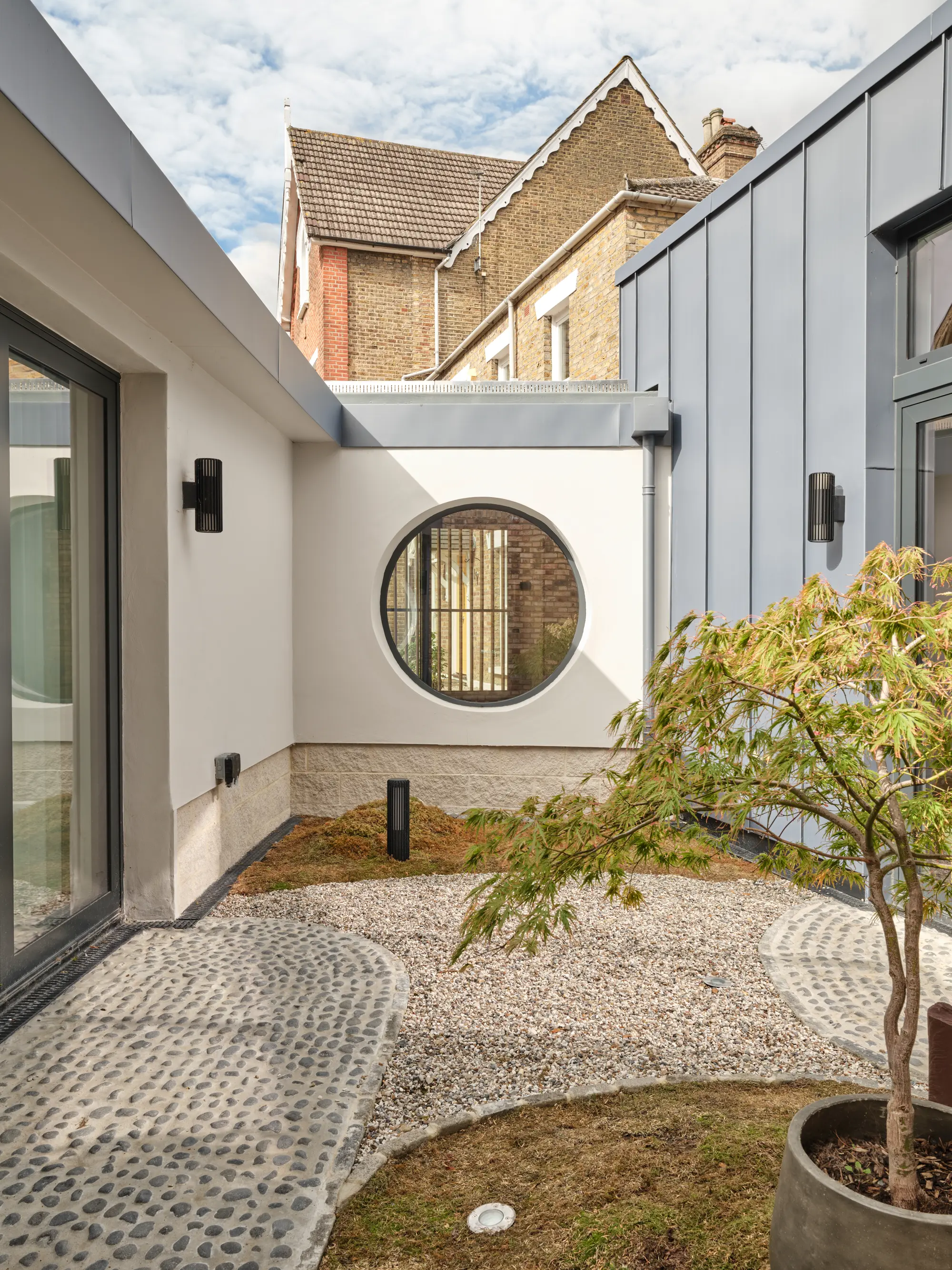 Low-lying infill extension doubles house size