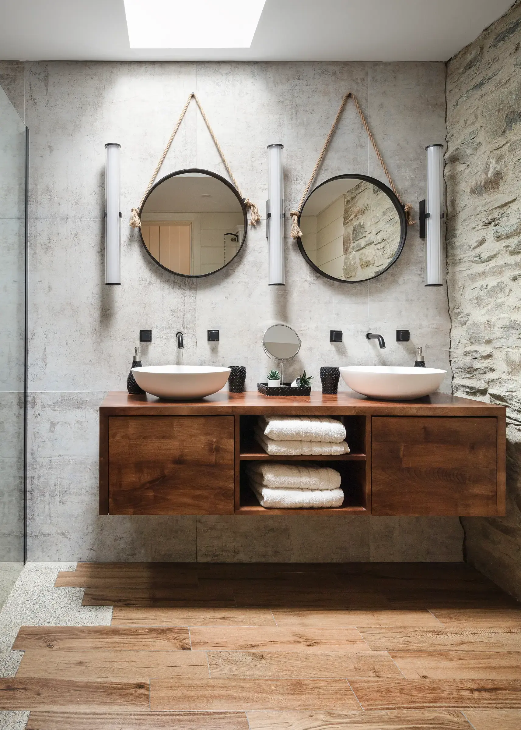 Stonework paired with concrete in a stylish historic cottage